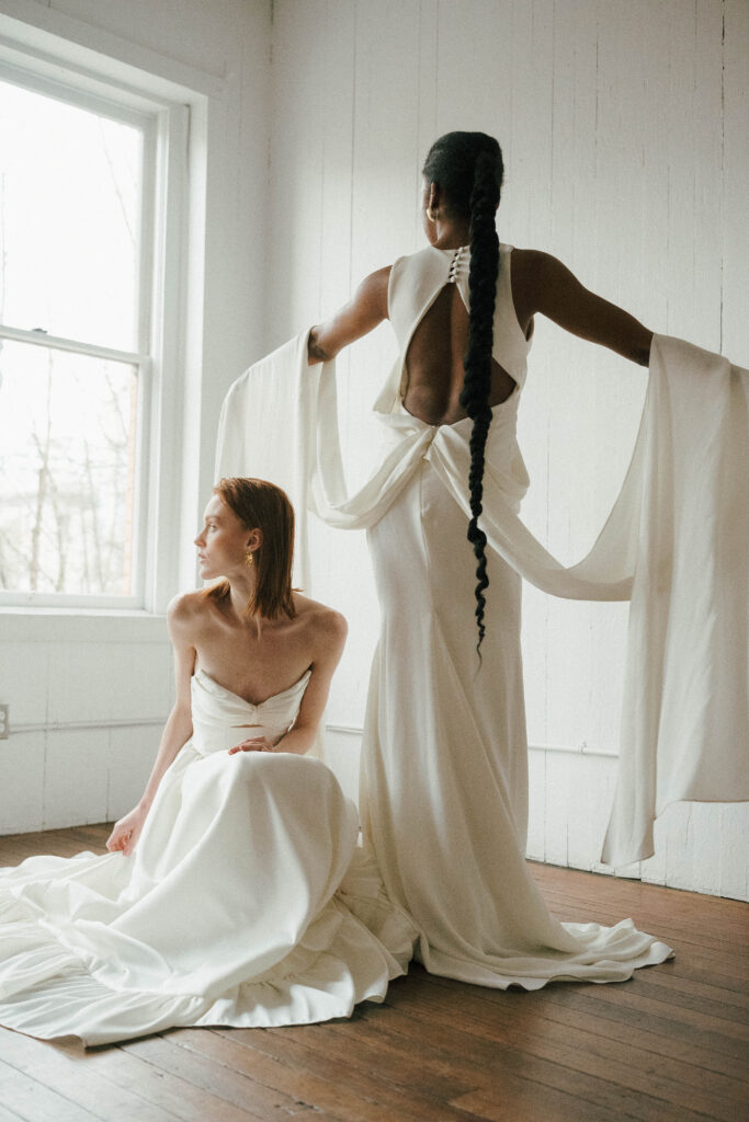 Bride twirling in an OUMA gown, showcasing its flowing train and modern silhouette.