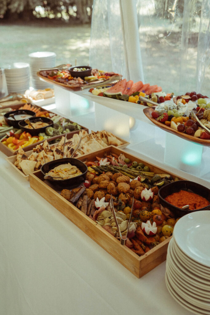 Colourful grazing table with fruit, vegetables, breads and charcuterie at Brock House.
