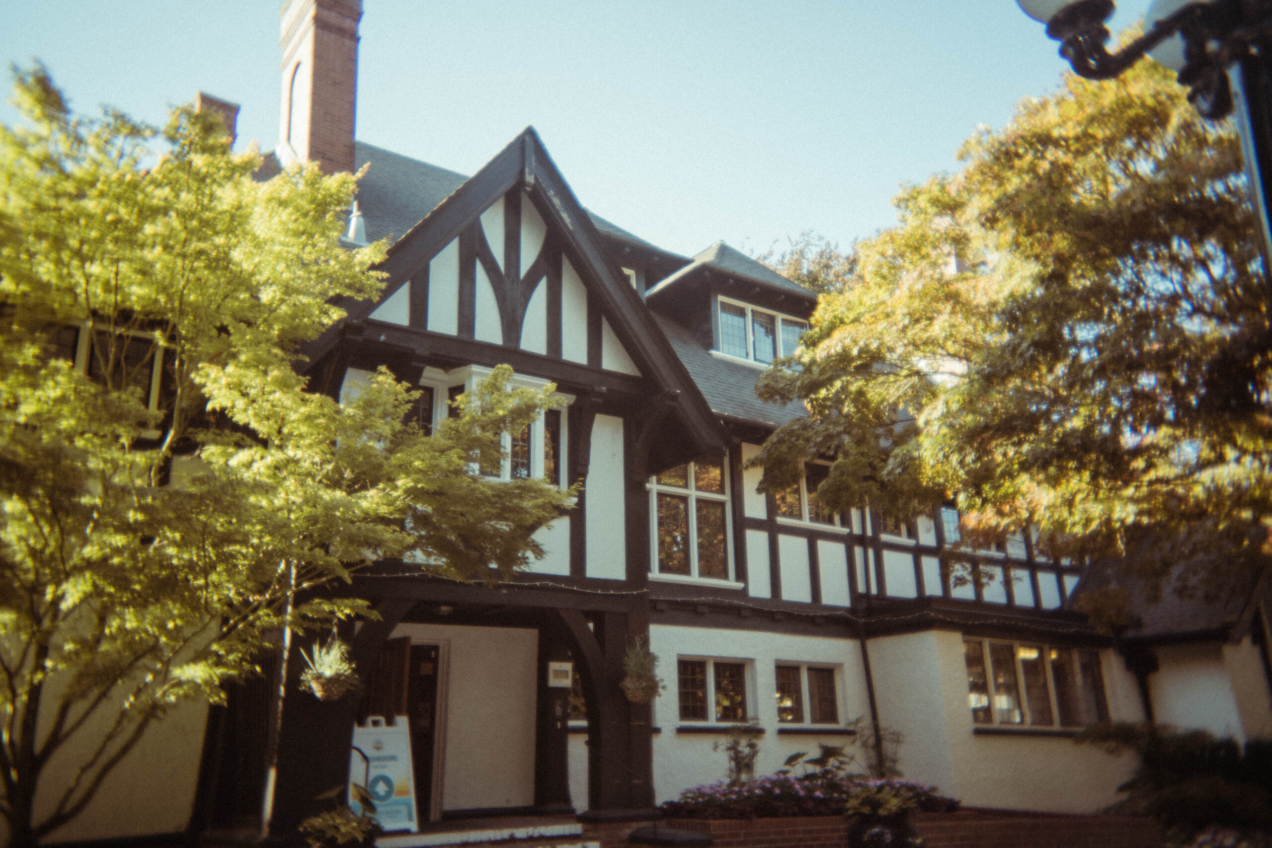 Tudor Revival entrance of Brock House with dark timber and white plaster walls.